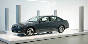 A new blue sedan on a showroom floor, a car that needs GAP insurance to cover the auto loan.